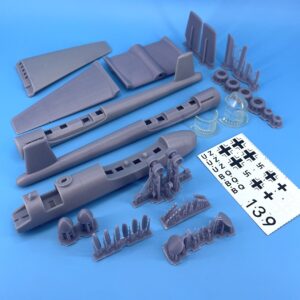 Plastic model kit assembly tools and parts on blue background.